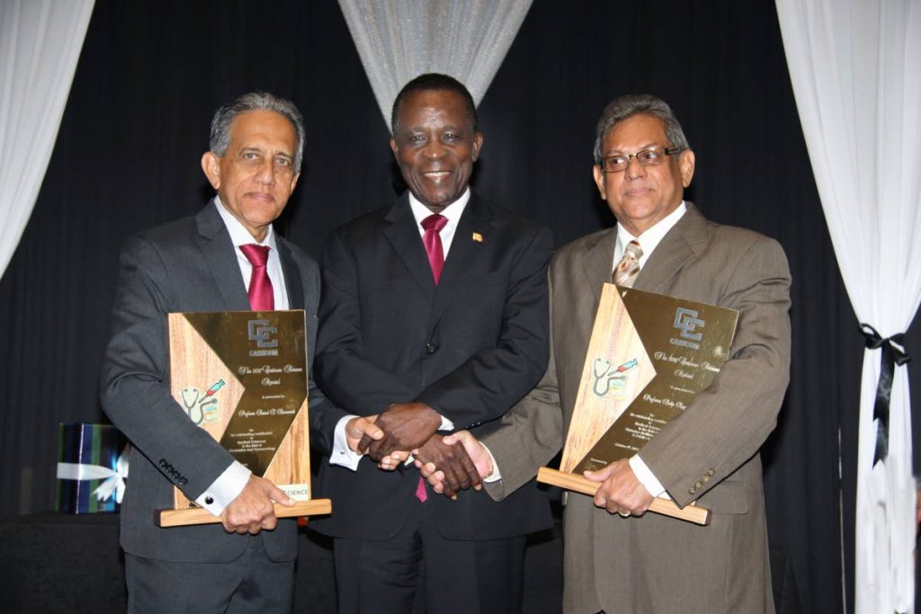 WINNERS: Grenada’s Prime Minister Dr Keith Mitchell with Trinis Prof Dalip Ragoobirsingh, right, and Prof Samuel Ramsewak, winners of the Caricom science award. PHOTO BY SUREASH CHOLAI