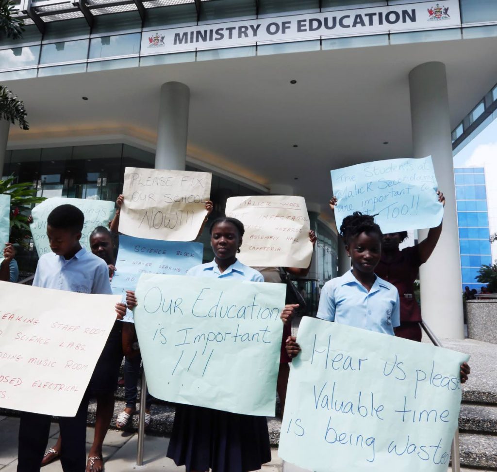 LESSON IN PROTEST: Students from the Malick Secondary School joined with members of the school’s PTA in a protest yesterday outside the Ministry of Educartion in Port of Spain over the dilapidated condition of the schoo. PHOTO BY AZLAN MOHAMMED