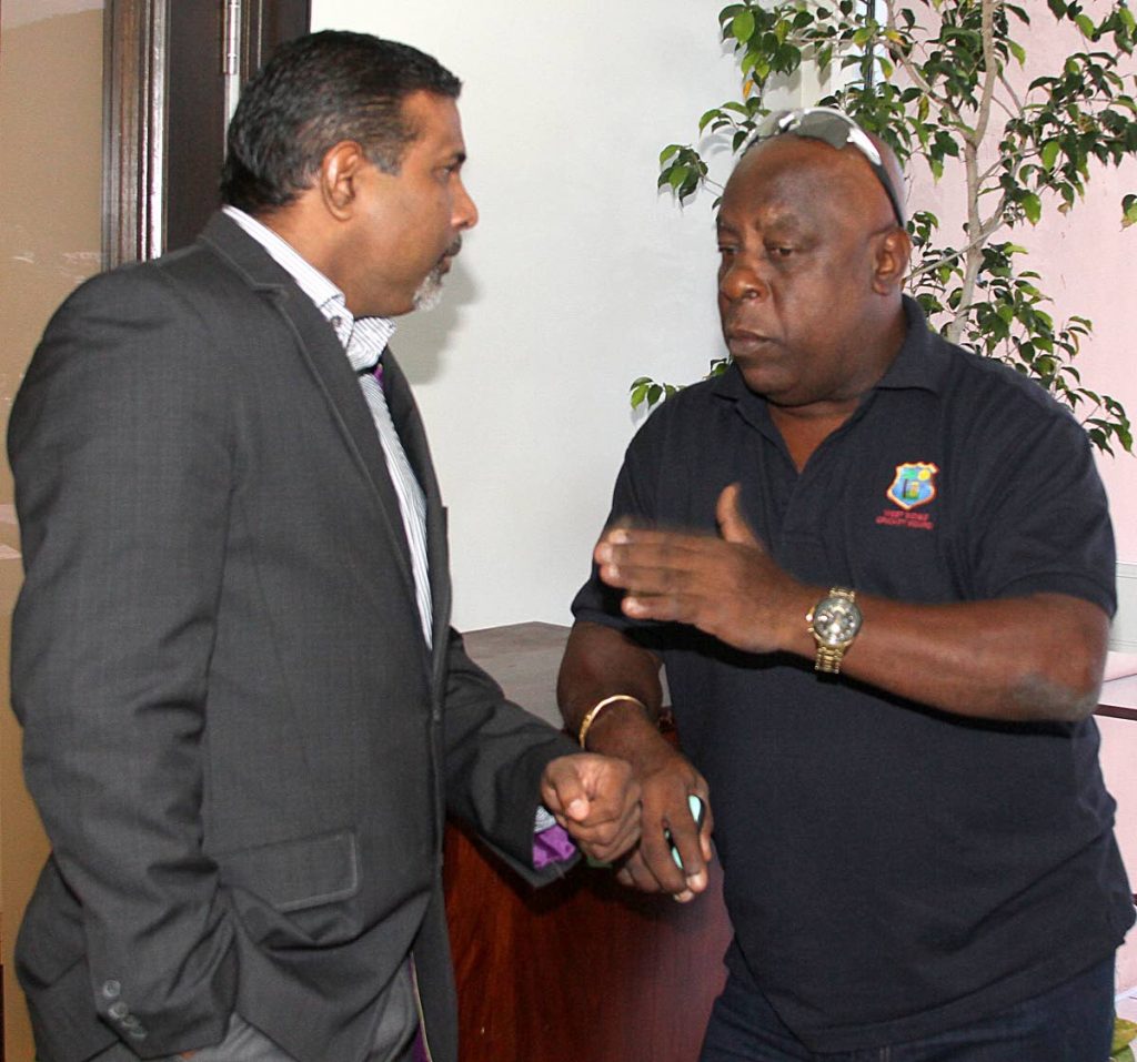 Sport Company Chairman and former Windies spinner Dinanath Ramnarine, left, chats with Cricket West Indies selector and Dominican Lockhart Sebastien at a press conference yesterday at the Queen’s Park Oval to highlight Saturday’s Hurricane Relief T20 match.