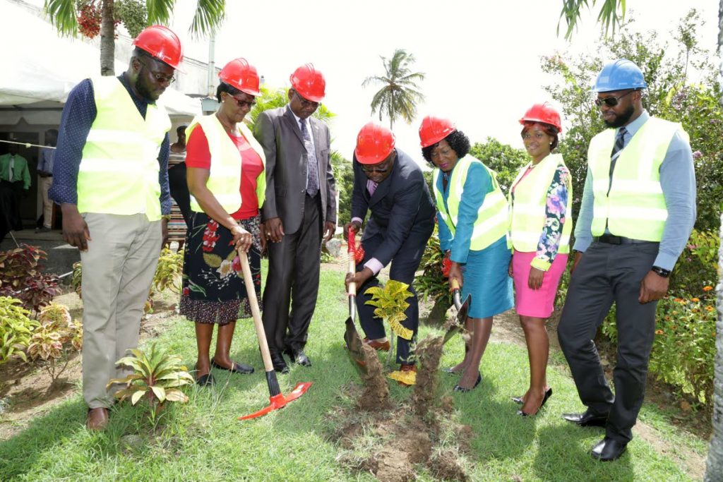 Tobago House of Assembly Chief Secretary Kelvin Charles, centre, turns the sod along with Secretary for the Division of Community Development, Enterprise Development, and Labour Marslyn Melville- Jack, to mark start of construction of the Belle Garden Multipurpose Facility on September 26. Others in photo, from left, are the Division's building maintenance service coordinator Neil Alleyne, president of the Belle Garden Village Council Pearl Beache, area representative and Secretary of the Division of Food Production, Hayden Spencer, MTS director Rosanna McKenna and manager of Protran (1997) Ltd, contractors on the project, Kenneth Dates