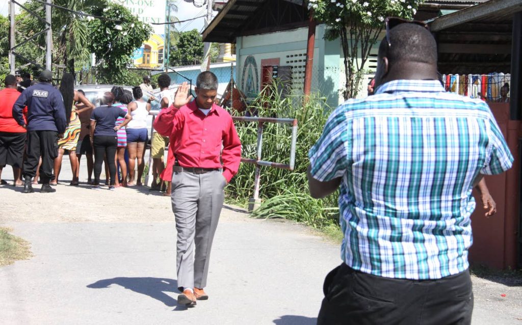 NO PHOTOS HERE: A policeman raises his hand as he tells a photographer not to take any photos following a face-off between residents and officers in the Beetham yesterday.