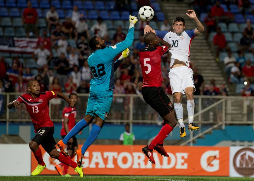 Trinidad and Tobago goalie Adrian Foncette, centre, punches the ball away from danger in a 2018 World Cup qualifier against USA on Tuesday at the Ato Boldon Stadium, Couva.