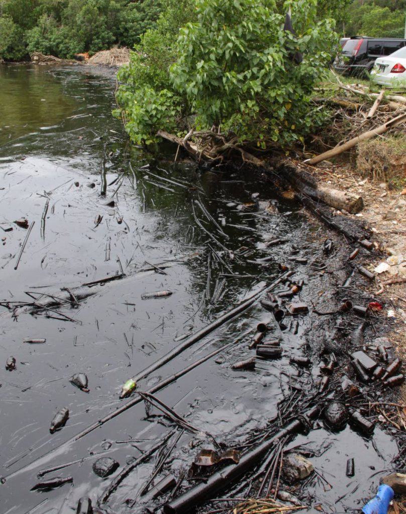 SERIOUS SITUATION: Oil smears the coastline at Anchorage, Chaguaramas, yesterday.