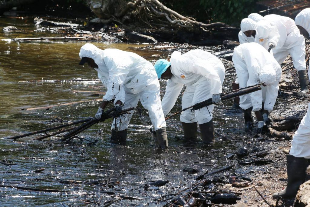 Kaizen Environmental Services workers involved in cleaning up yesterday after an oil spill affected the north-western peninsula in Chaguaramas.