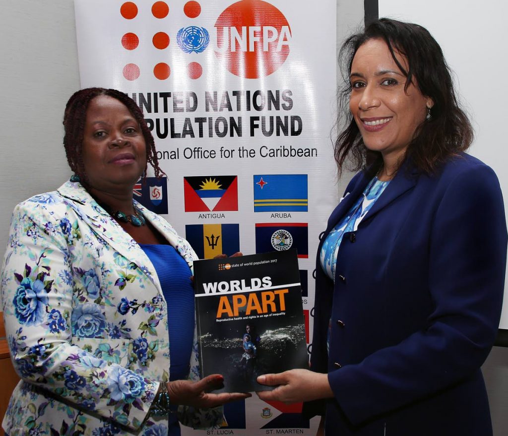 At right, UNFPA liaison officer Aurora Noguera - Ramkissoon presents a copy of the 2017 report tiled 'Worlds Apart