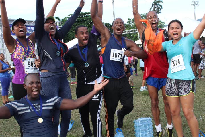 Participants celebrate after completing Maritime’s 5K Fun Run and Walk event last Saturday in Port of Spain.