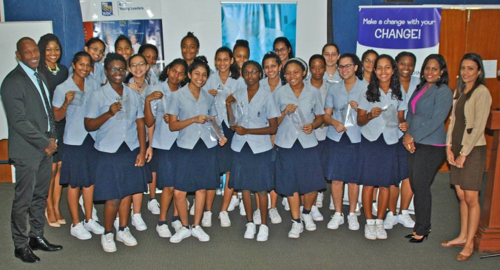 Students of St. Joseph’s Convent, Port of Spain, proudly show off their coin collection bags at the launch of RBC/WE Schools ‘Change 4 Change’ project aimed at the collection of coins to benefit communities in Trinidad and Tobago. Sharing in the special moment are (from left) Darryl White, RBC Royal Bank Managing Director and Wendy Alleyne, Senior Manager, Brand & Sponsorship – Products, Marketing & Channels, RBC Royal Bank; Hazel Ann Marshall (second from right), Senior Manager,Products, Marketing and Channels, RBC Royal Bank; and Nia Sampath, teacher, St. Joseph’s Convent.