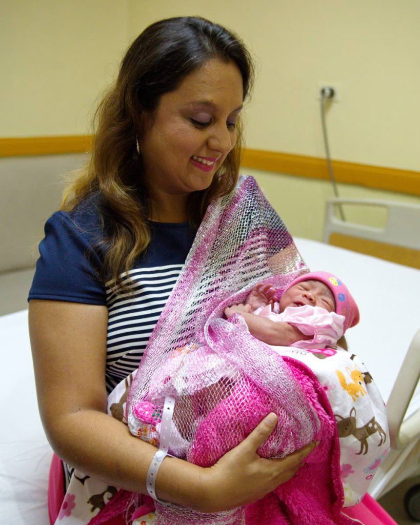 Couva North MP Ramona Ramdial cuddles her newborn daughter Anuja Vivja Barrath.