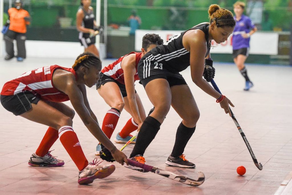 Trinidad and Tobago’s Jordan Viera, right, is marked by two Guyanese players in their Pan Am Indoor Cup match yesterday at Cliff Anderson Sports Hall, Georgetown, Guyana.