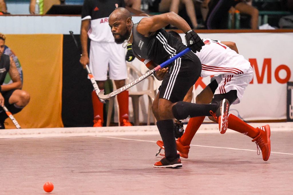 Trinidad and Tobago captain Solomon Eccles makes a pass during a Pan Am Indoor Hockey match against Canada yesterday at the Cliff Anderson Sports Hall, Georgetown, Guyana.