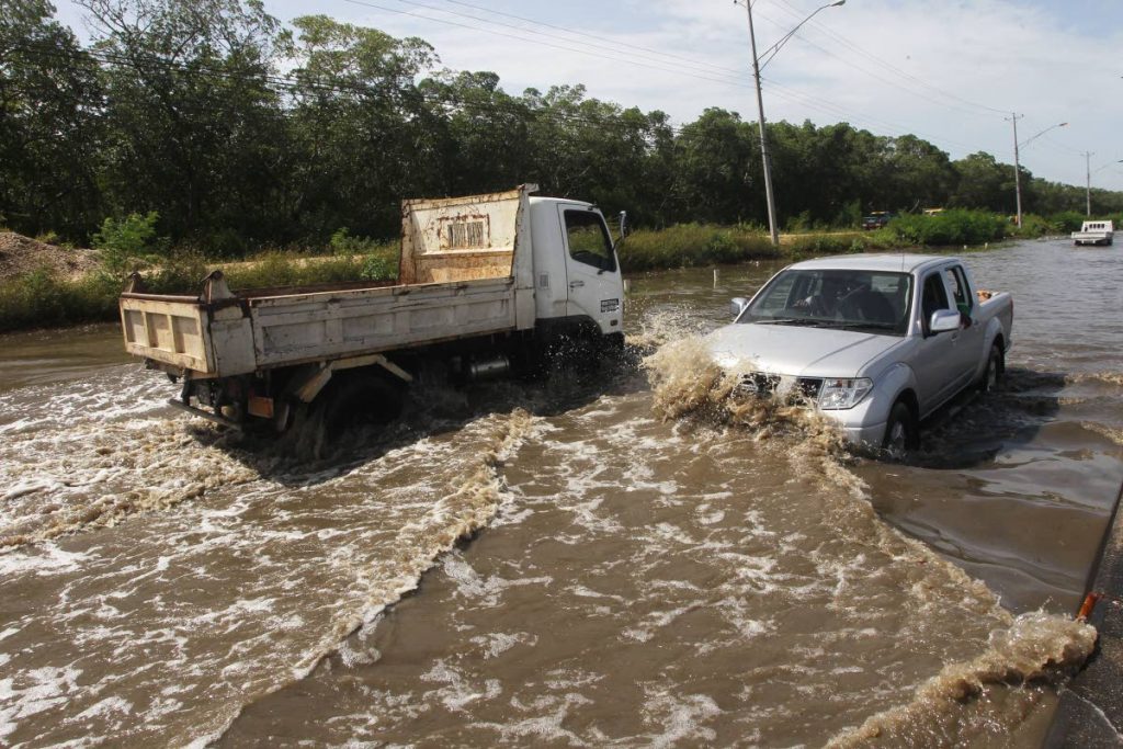 FLASHBACK: Drivers brave flood waters along Mosquito Creek on Saturday. 