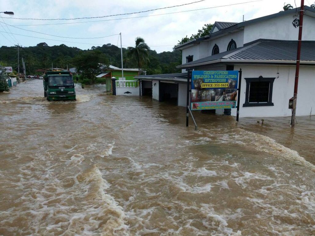 Flood on main road: A truck driver proceeds cautiously through Mafeking Main Road where houses and businesses flooded yesterday. Photo courtesy David Law