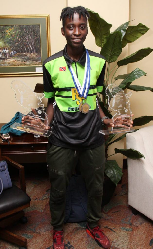National cyclist Teneil Campbell shows off her Caribbean Road Cycling trophies yesterday.