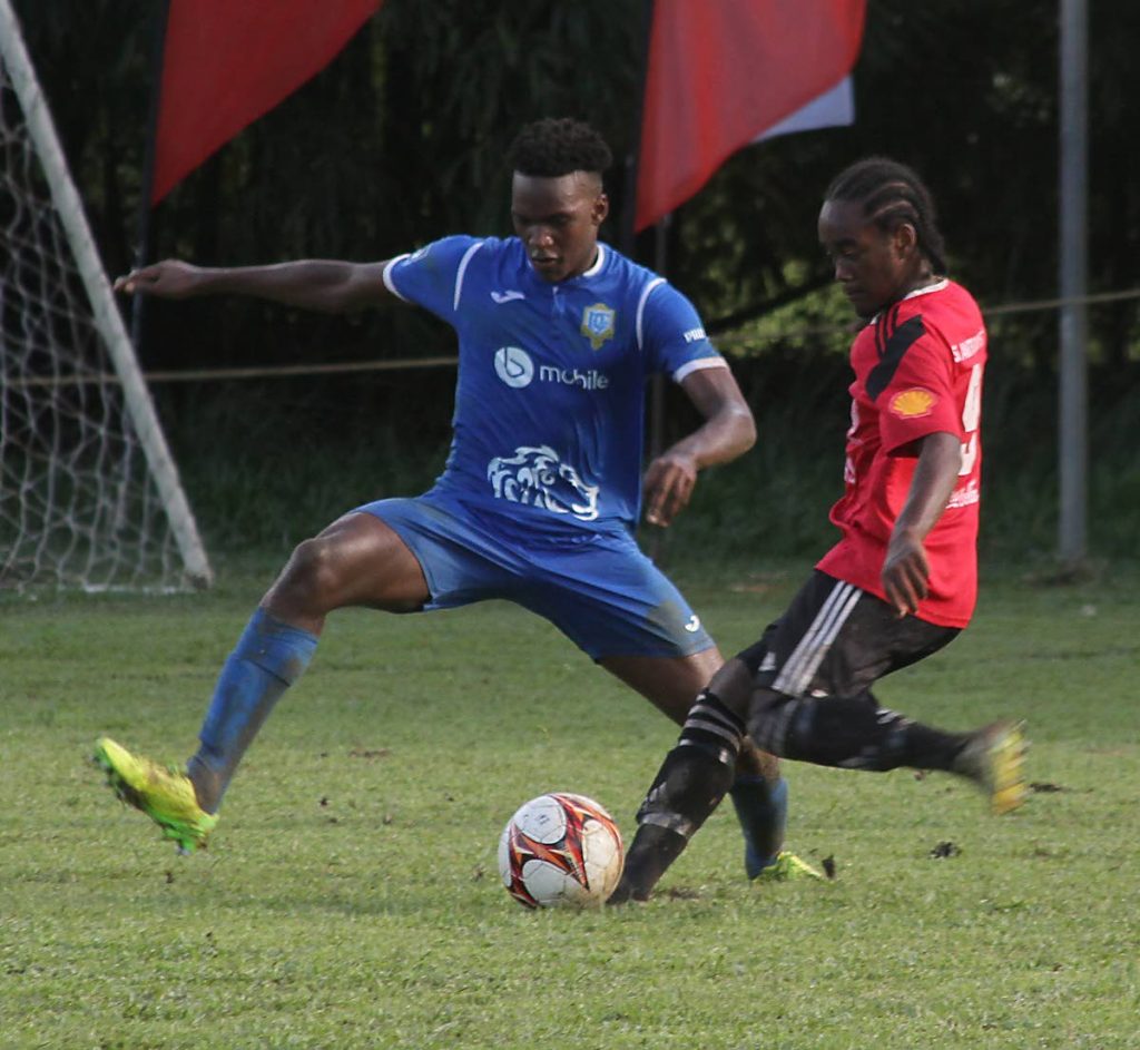 St Anthony's midfielder Che Benny (right) prepares to fire a shot on goal despite the presence of a Presentation San Fernando defender, during their SSFL Premier Division match yesterday.