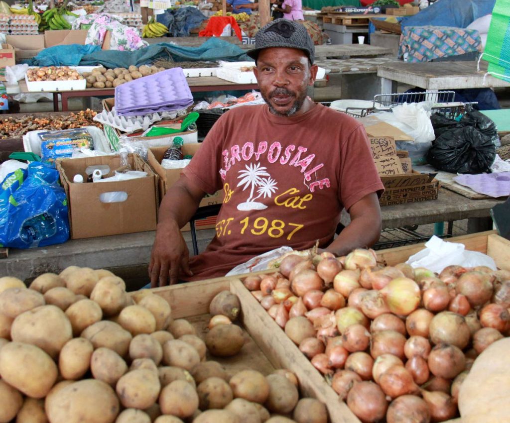 PRICE HIKE: San Fernando market vendor, Lincoln Lewis, talks with Newsday yesterday at the market about the hike in the price of produce due in part to the recent rise in cost of fuel.