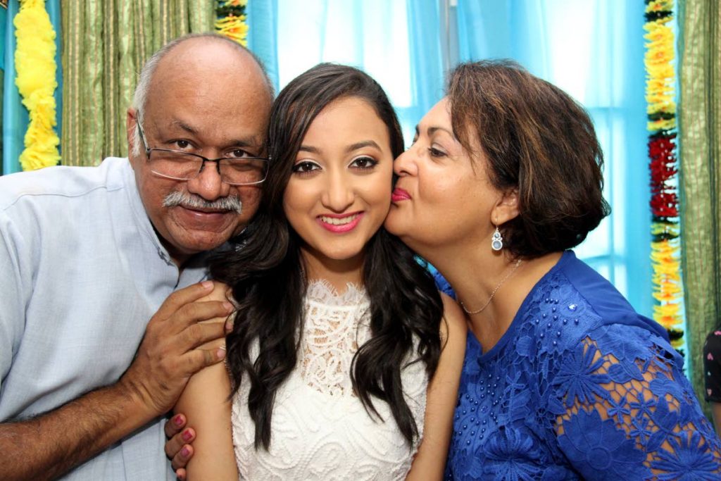 PROUD: Dr Parmanand Maharaj and his wife Sandra Gajraj-Maharaj with their daughter Saanjali Maharaj formerly of SAGHS, who won the President’s Medal. PHOTO BY SUREASH CHOLAI
