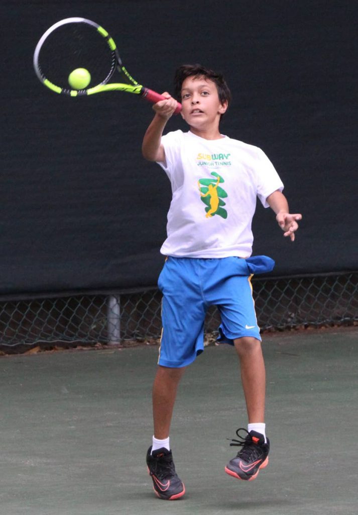 Beckham Sylvester in action at the Subway Junior Tennis Tournament on Saturday at the Trinidad Country Club, Maraval.