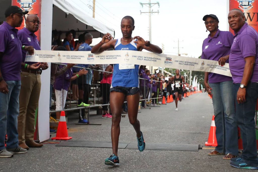 Matthew Hagley crosses the finish line fourth overall 
but was the first Trinbagonian finisher at the UWI International Half-Marathon yesterday in St Augustine.