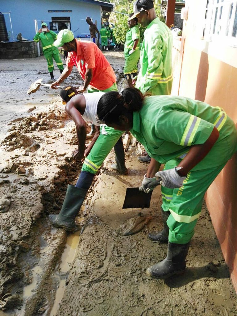 A Cepep crew helps clear mud from a residence in Mayaro after a flood in 2016.