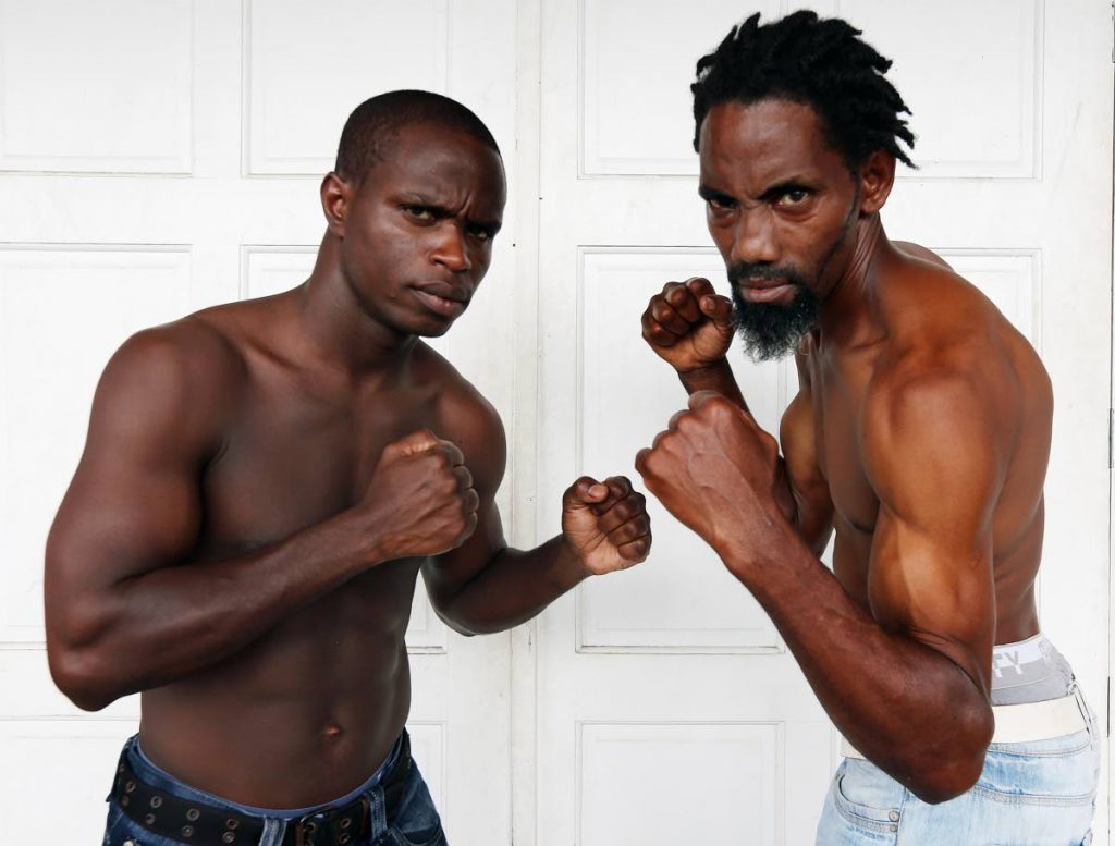 Trinidad and Tobago’s Prince-Lee Isidore, left, squares up against Bajan Shurwyn Marshall at their weigh-in ceremony at the National Boxing Centre, Hasely Crawford Stadium, yesterday, ahead of their super lightweight bout tonight.