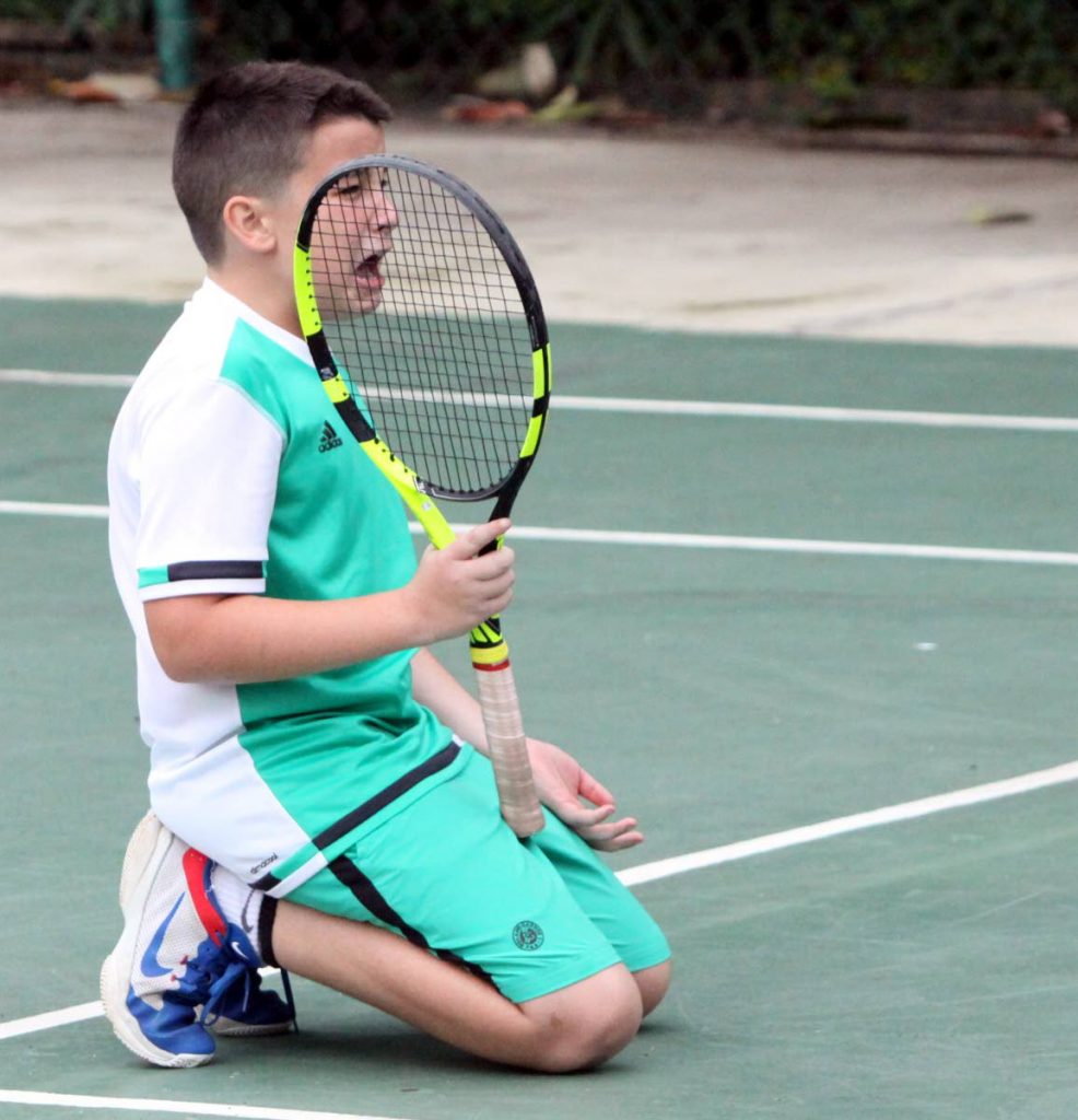 Declan Sheppard gets emotional in a boys Under-12 singles match against Alexander Merry at the Subway Junior Tennis Tournament at the Trinidad Country Club in Maraval, on Friday. Merry won the quarterfinal match 4-5, 4-1, 10-8.
