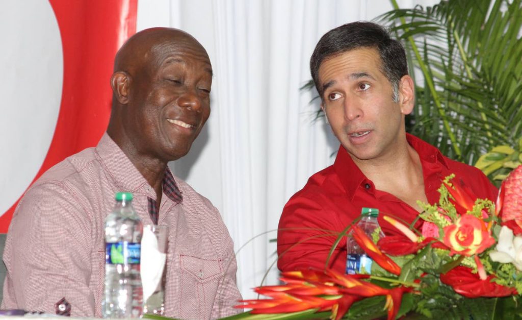 Prime Minister Dr Keith Rowley and Attorney General Faris Al Rawi chat while at a meeting hosted by Dr Rowley’s Diego Martin West executive at the Pt Cumana Community Centre, Carenage, yesterday.