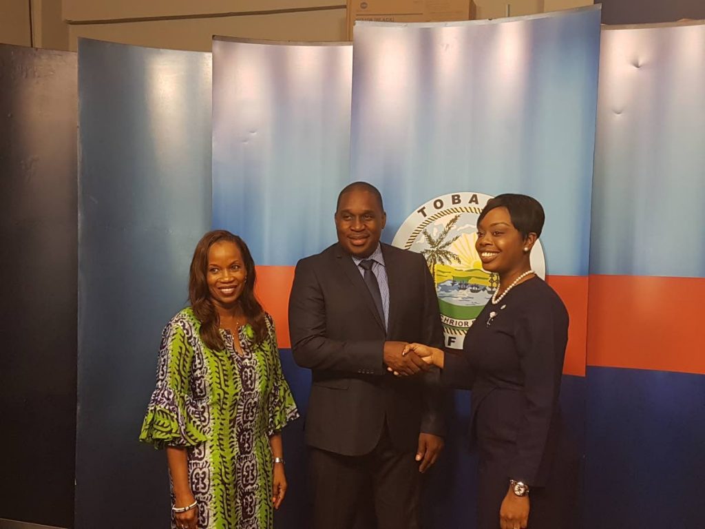 Secretary of Tourism, Culture and Transportation Nadine Stewart-Phillips, right, congratulates new chief executive officer of the Tobago Tourism Agency (TTA) Louis Lewis, as TTA chairman, Dr Sherma Roberts looks on.
