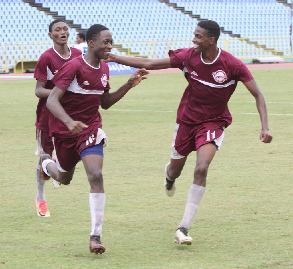Kevon Edwards of East Mucurapo, centre, celebrates his goal with teammates yesterday in an Intercol match against Diego Martin North yesterday at the Hasely Crawford Stadium, Mucurapo.