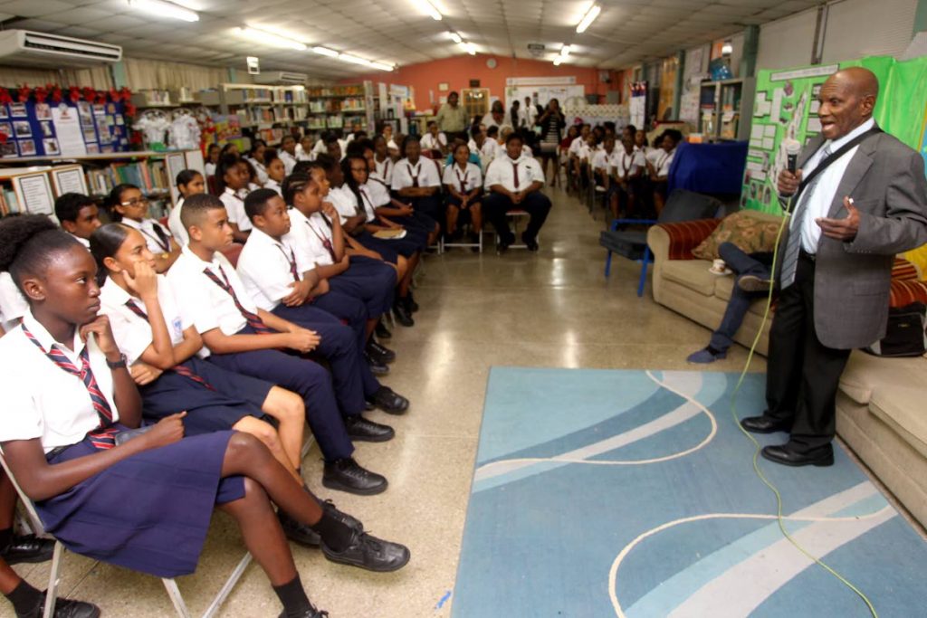 SCHOOL VISIT: Historian Michael Anthony  and author of  “Green Days by the River” speaks with students of the Marabella North Secondary school at the school’s library yesterday.