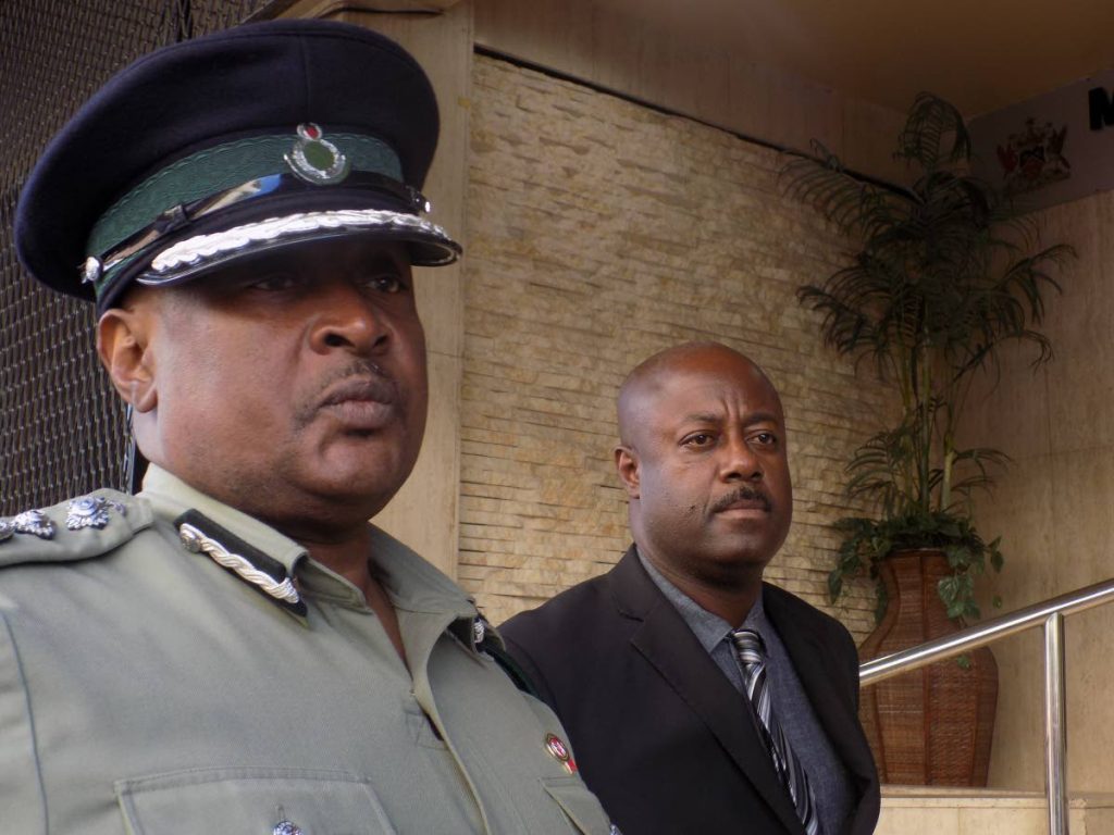 Acting Commissioner of Prisons William Alexander, left, and President of the Prison Officers Association Ceron Richards speak with reporters outside the Ministry of National Security Building on Temple Court on Tuesday.