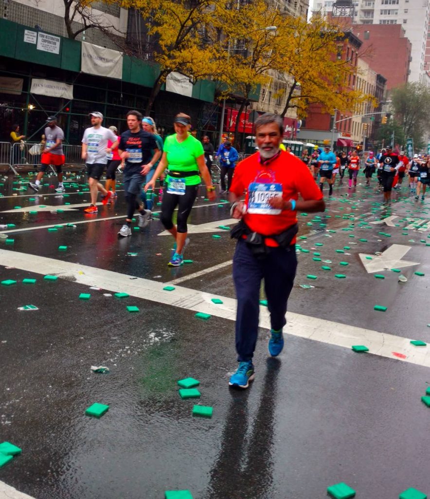 Dr Everord Hosein, right, runs at the 2017 New York Marathon last Sunday.