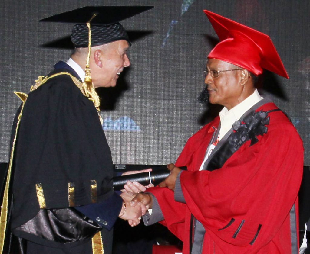 Chief honoured: President Anthony Carmona congratulates Santa Rosa First People’s Chief Ricardo Bharath on his Honorary Distinguished Fellow award at UTT’s graduation, O’Meara campus on Wednesday. PHOTO BY ANGELO MARCELLE