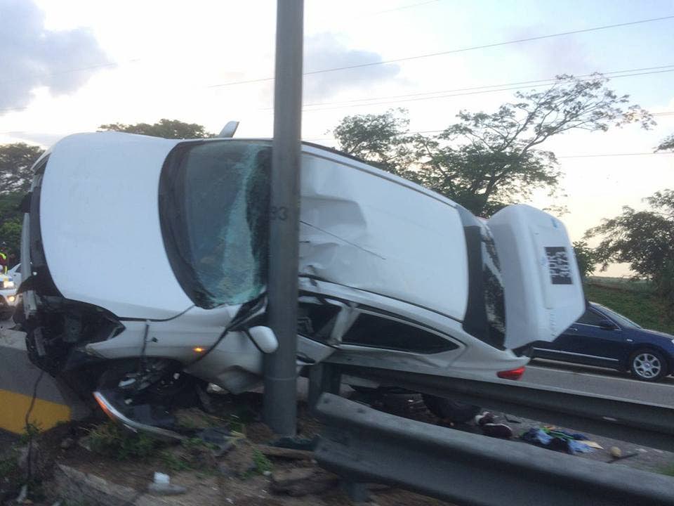 A Nissan City motorcar is pinned against a light pole by a Hilux during an early morning collision yesterday. The occupants of both vehicles escaped with minor injuries.