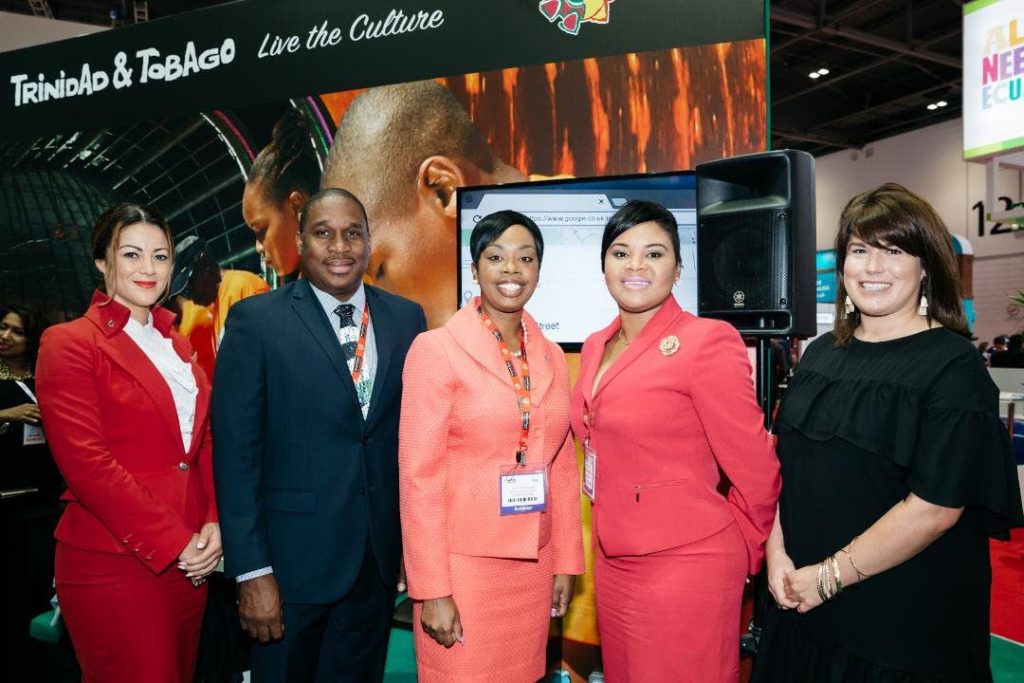 Tourism Minister Shamfa Cudjoe, second from right, and Tourism Secretary Nadine Stewart-Phillips, third from right, ose for a photo with, from left, a representative from Virgin Atlantic, Louis Lewis, Chief Executive Officer, Tobago Tourism Agency, and Lizzy Davis, Content Creator, Virgin Atlantic at the World Travel Market 2017 in London on Monday.