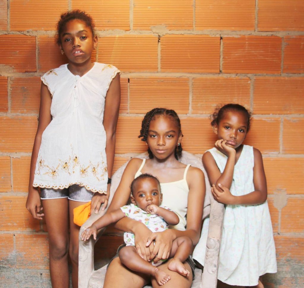Safe and sound: The Mason siblings, left to right, Kerry-Ann, Kerry, Katlyn and baby Kennedy at the home of a relative in Rio Claro on Friday. The children were rescued from a fire which gutted their home in Mayaro on Wednesday. Photo by Vashti Singh