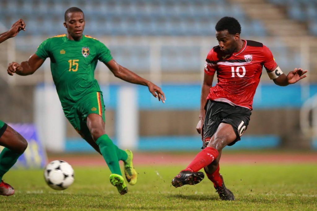 Trinidad and Tobago captain Kevin Molino, right, shotts to score a stoppage time equaliser against Grenada in an international friendly on Saturday at the Ato Boldon Stadium, Couva. The match ended 2-2. Photo: Allan V. Crane/CA-images.
