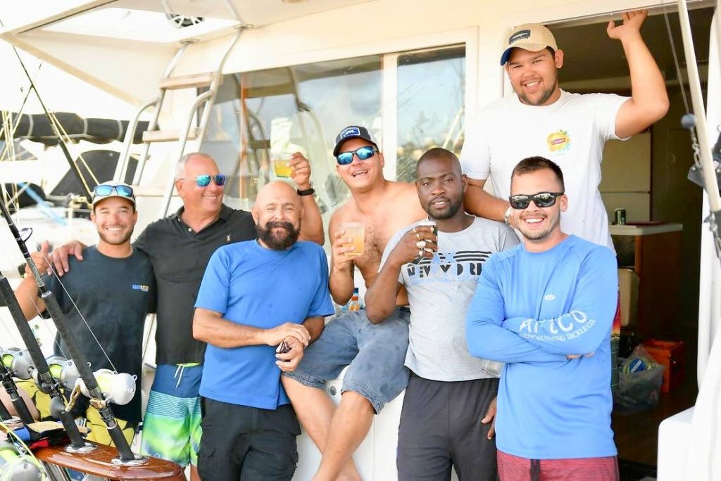 Team Vesper celebrate their victory at the 26th St Lucia Billfish Tournament on Saturday. The members are (from left to right) Peter Reid, Jerome McQuilkin, Derek Tardieu, Skipper Adrian De Silva, Ritchie Neverson, Joshua Camacho (in back) and Christian Valdez, the winner of the best angler of the tournament (in front).