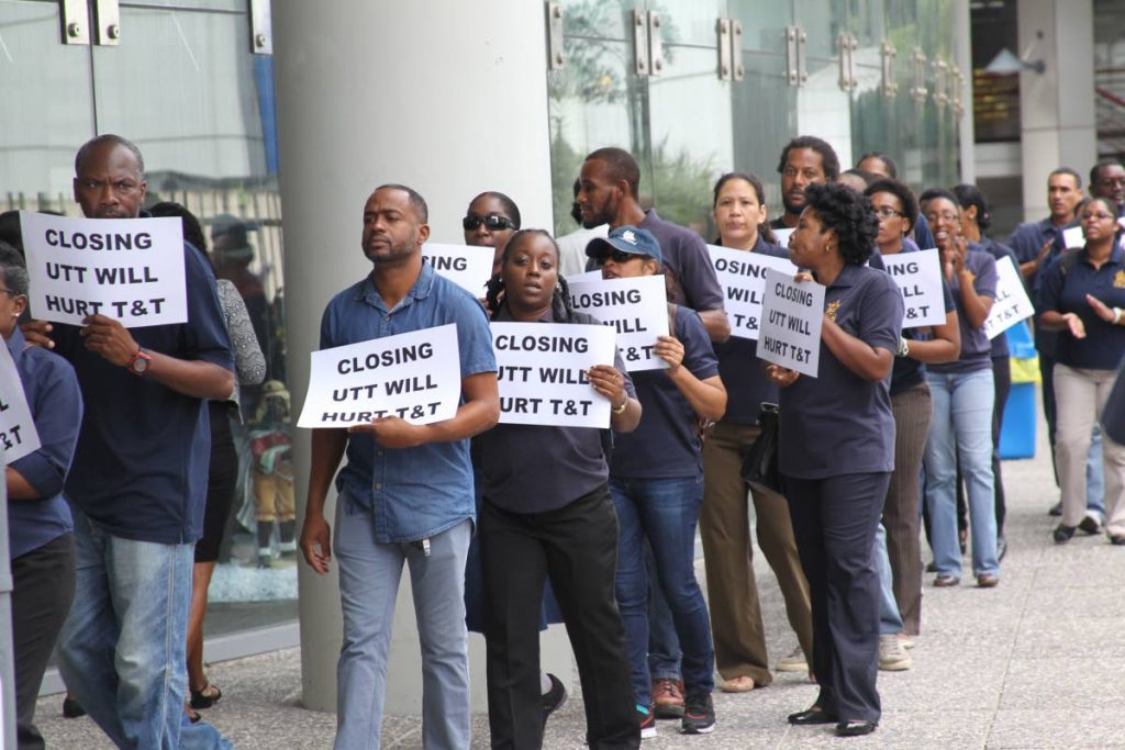  UTT staff from various campuses protest outside the Ministry of Education on St Vincent Street, Port of Spain yesterday.