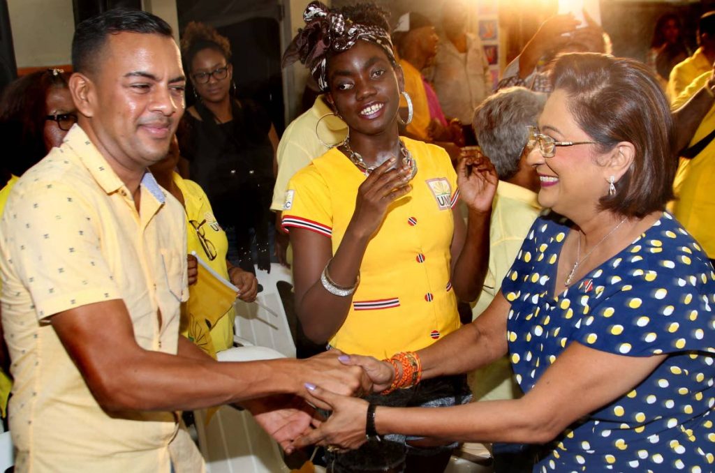 FULL SUPPORT: United National Congress leader Kamla Persad-Bissessar greets supporters at the party’s Monday Night Forum at St Helena Hindu School.   PHOTO BY AZLAN MOHAMMED