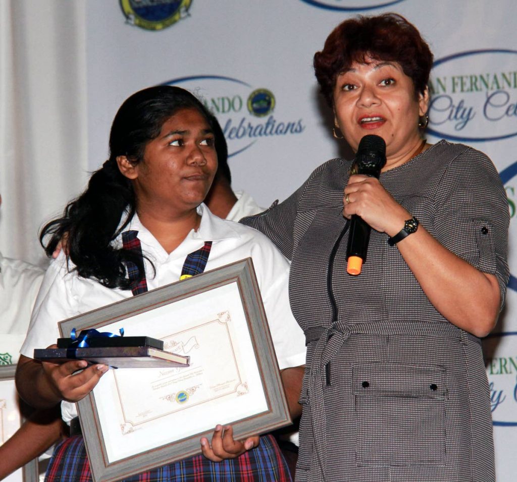 San Fernando Deputy Mayor Vidya Mungal-Bissessar, right, congratulates Nazma Gainder of San Fernando West Secondary School after she won the Best Essay at the San Fernando City Week Essay Competition.