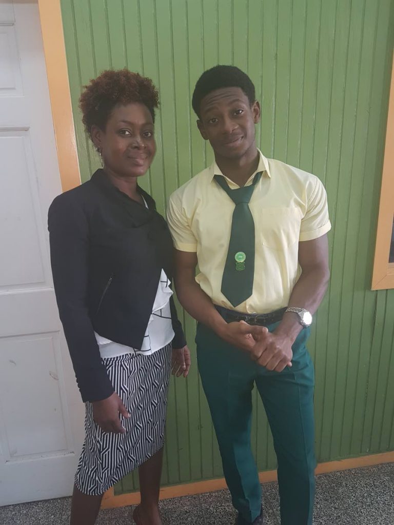 Signal Hill Secondary student, Kemeul Henry Abraham, who placed fourth in the Caribbean in CAPE Level 1 Building and Mechanical Engineering Drawing at CAPE, shares a moment with his mother, Stacy Abraham, who is also his teacher for this subject, at the school on Monday.