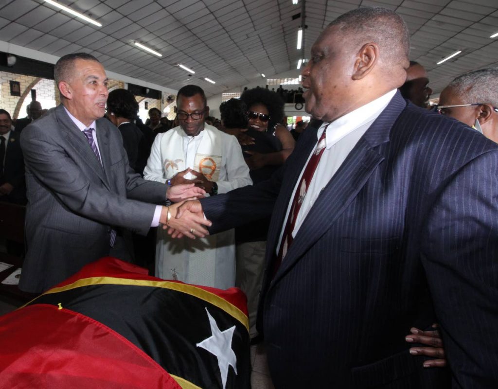 SUPPORT: High Court Judge Justice Malcom Holdip (right) is greeted by President Anthony Carmona, a former judge, at the funeral for his wife Dianne Marshall-Holdip at the Our Lady of Fatima RC Church in Curepe yesterday.