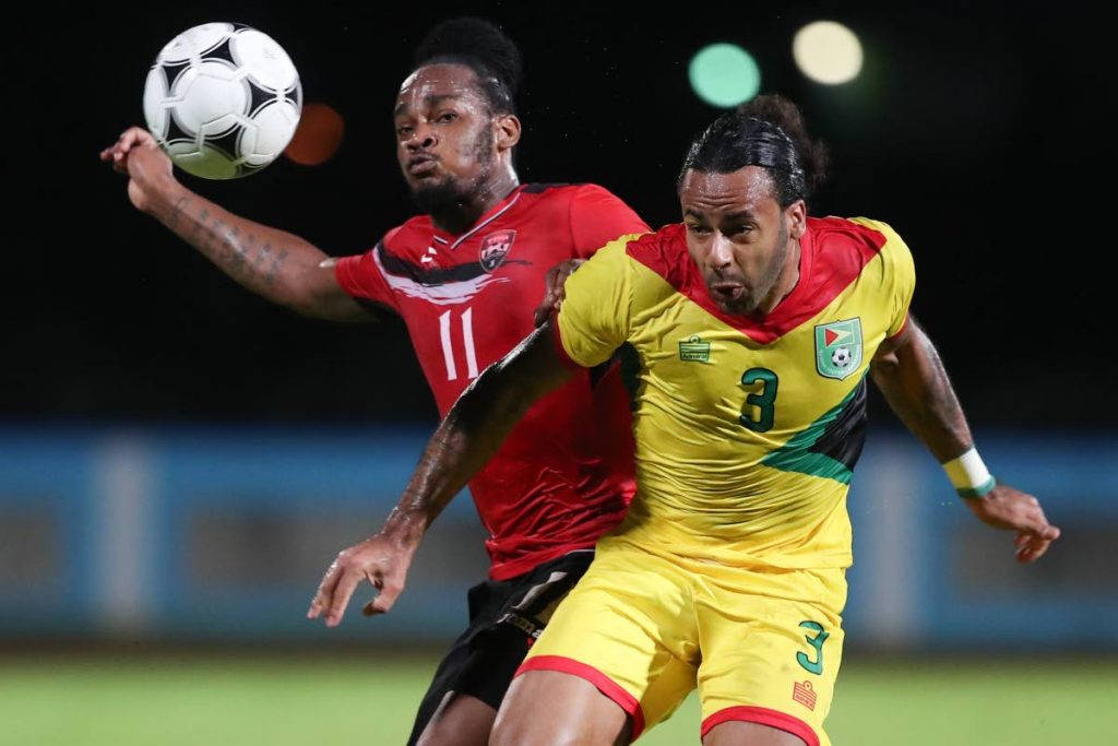 Guyana’s Christopher Bourne, right, and Trinidad and Tobago’s Neil Benjamin challenge for the ball in an international friendly at the Ato Boldon Stadium, Couva.