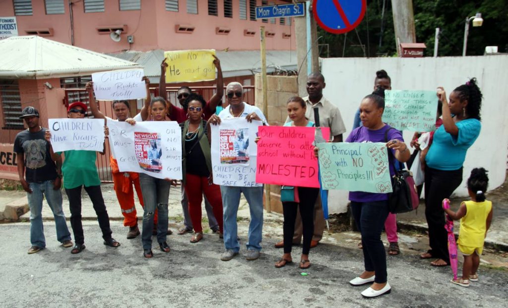 PROTEST ACTION: Parents of San Fernando Methodist primary school students continue their protest action against the return of a teacher at the school yesterday.