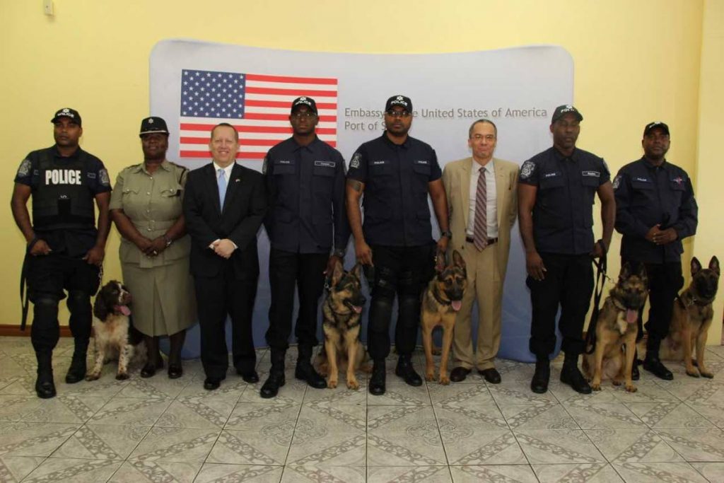 US Embassy and police officials with five dogs provided by the US.