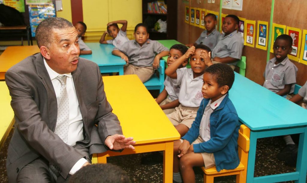 BACK TO SCHOOL: President Anthony Carmona sits and chats with students of the San Fernando Boys’ RC School during a visit yesterday on the occasion of Universal Children’s Day.  PHOTO BY ANSEL JEBODH