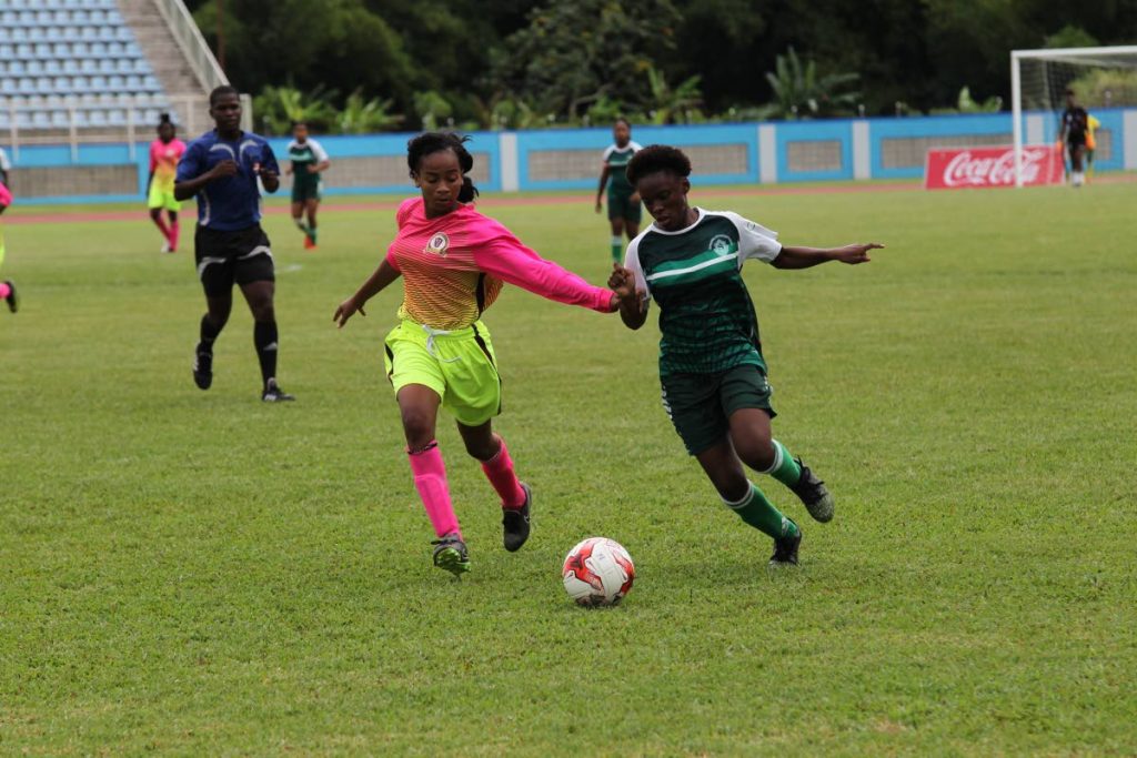Pleasantville Secondary’s Kayla Maillard, left, battles St Augustine Secondary’s Mya Hernandez in the First Citizens National Girls Big 5 final at the Ato Boldon Stadium, Couva, yesterday.