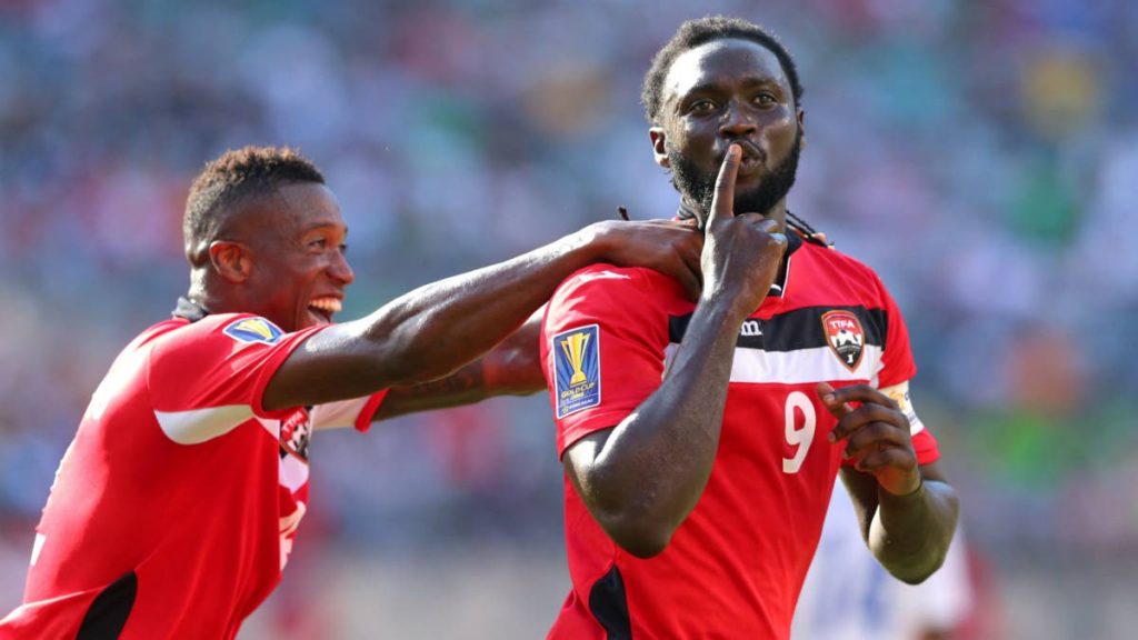 Former national captain Kenwyne Jones, right, celebrates after scoring at the 2015 CONCACAF Gold Cup.