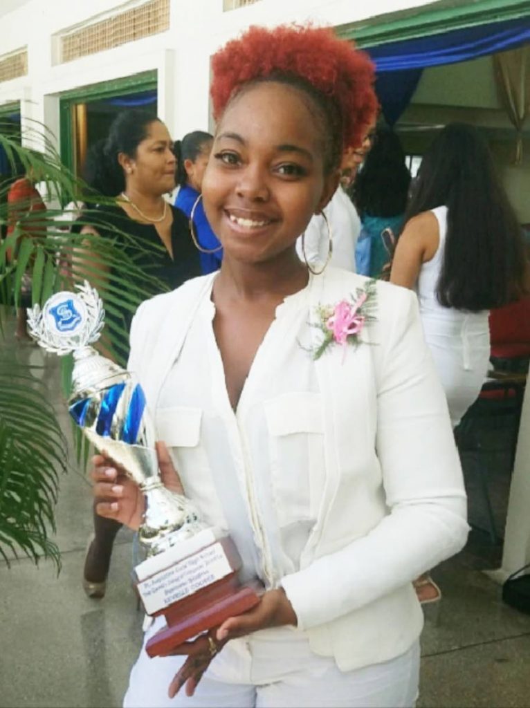 Major achievement: Scholarship winner Kevelle Cooper and her award on her graduation from St Augustine Girls’ High School.