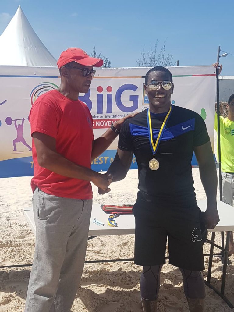 Trinidad and Tobago’s Martin Joseph, right, is congratulated after placing second in the beach wrestling final at the Barbados Invitational Independence Games, recently.